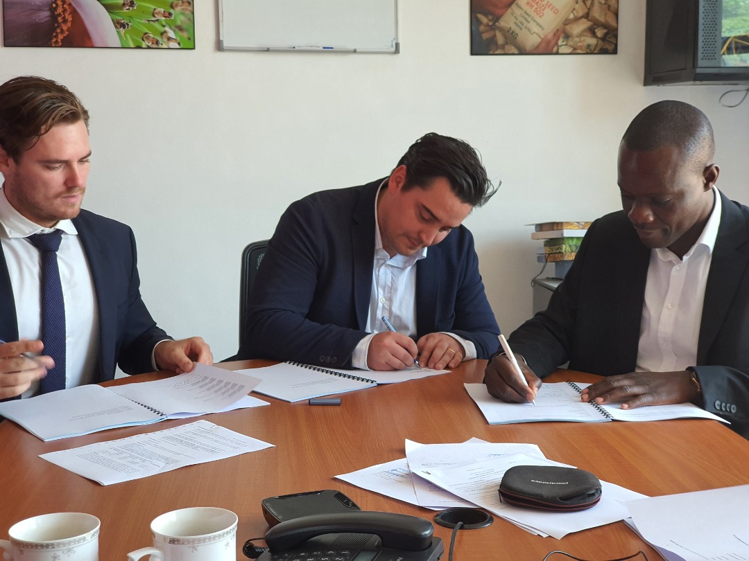 Founders and investors signing a deal together at the table